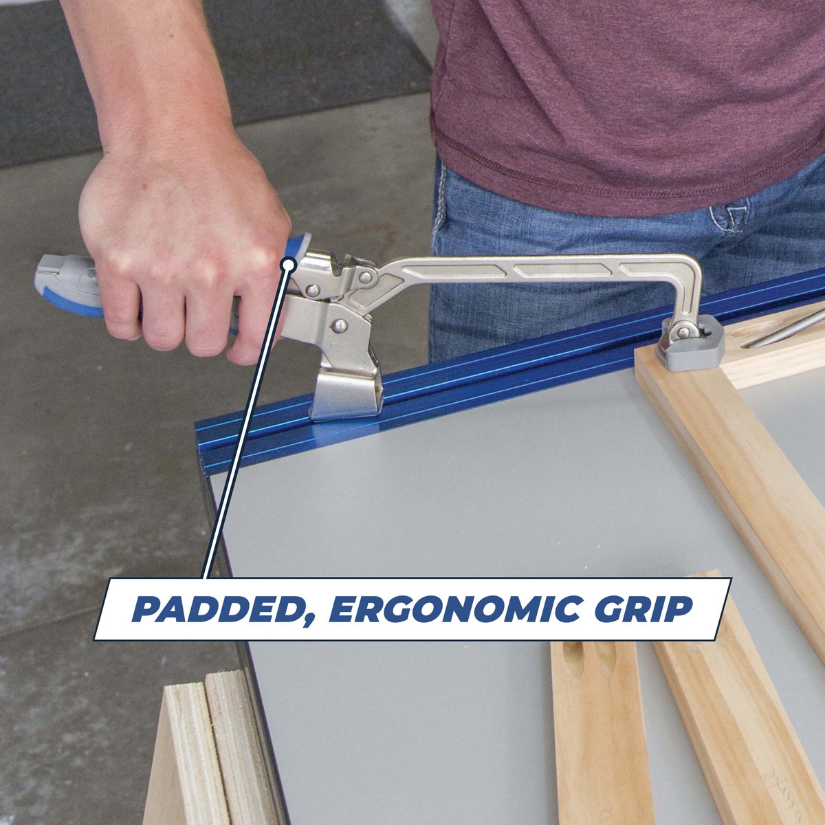 Kreg KBC6 Bench Clamp 6 in clamping a wood workpiece to a benchtop track for assembly and layout