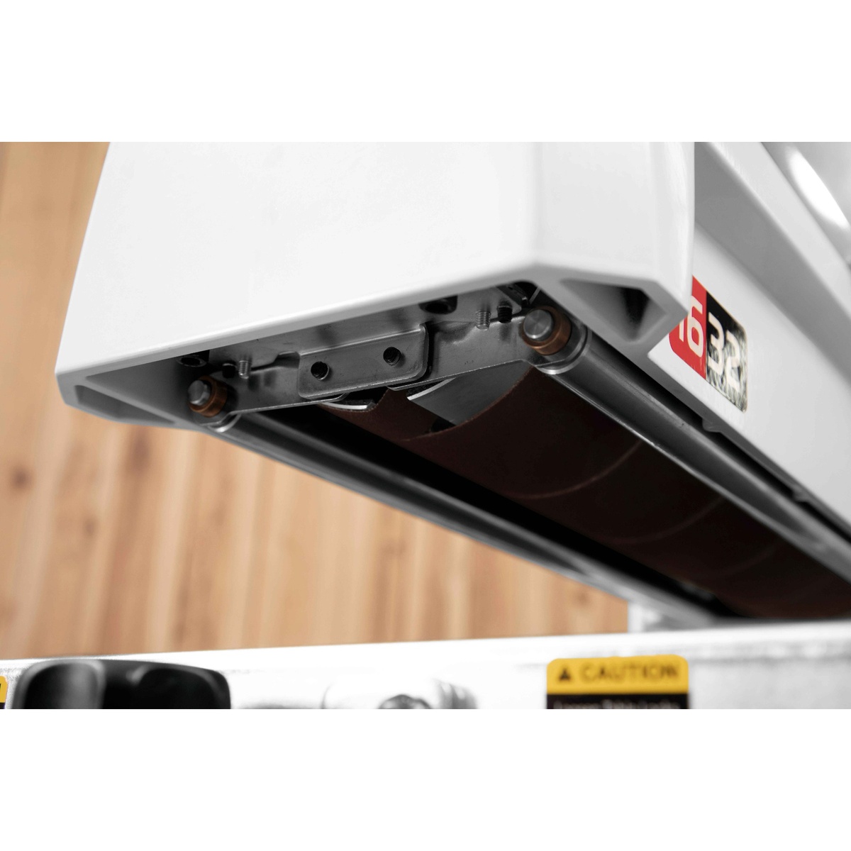 JET JWDS-1632 Drum Sander with Stand underside dust hood and drum area designed to direct sanding dust from wood panels to dust collection in a shop