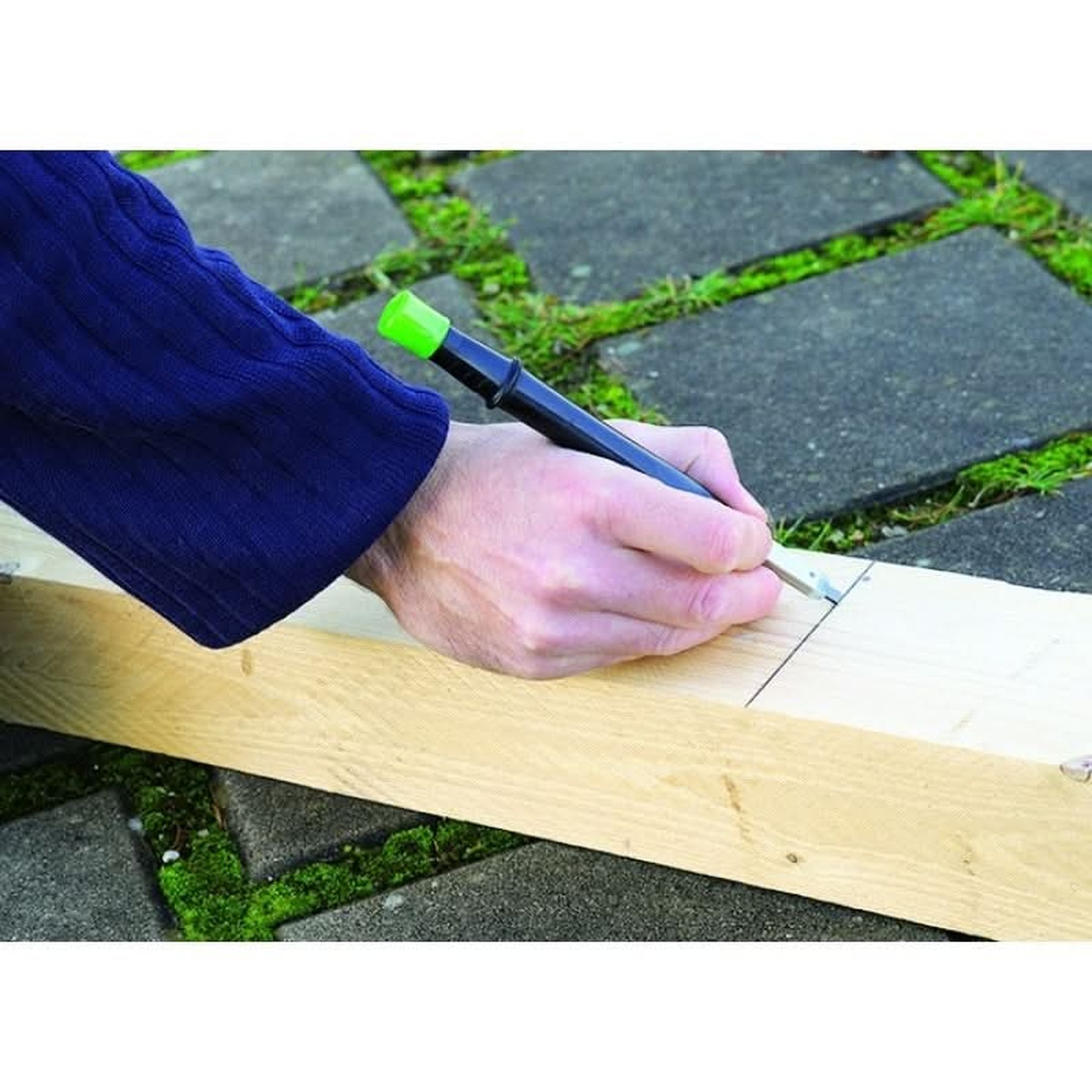 Pica BIG Dry 6060 Longlife Construction Marker marking a layout line on framing lumber during outdoor jobsite work