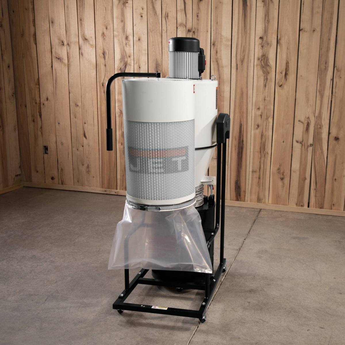 Jet JCDC-1.5 Cyclone Dust Collector, 1.5HP, 115V shown assembled in a woodworking shop with collection bag installed on the base for chip and dust collection