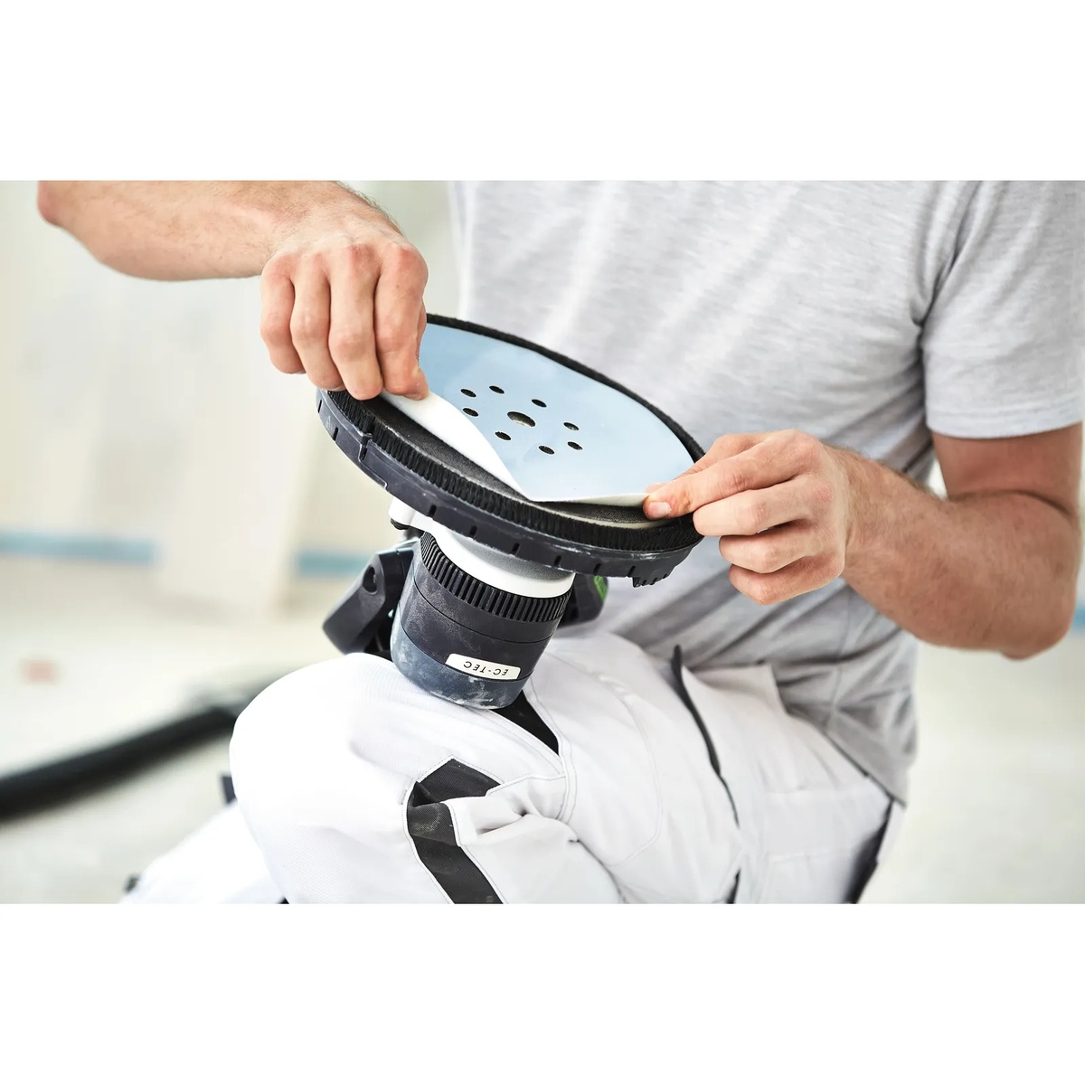 Festool 571935 Planex Easy Drywall Sander sanding pad with abrasive disc being installed during drywall prep