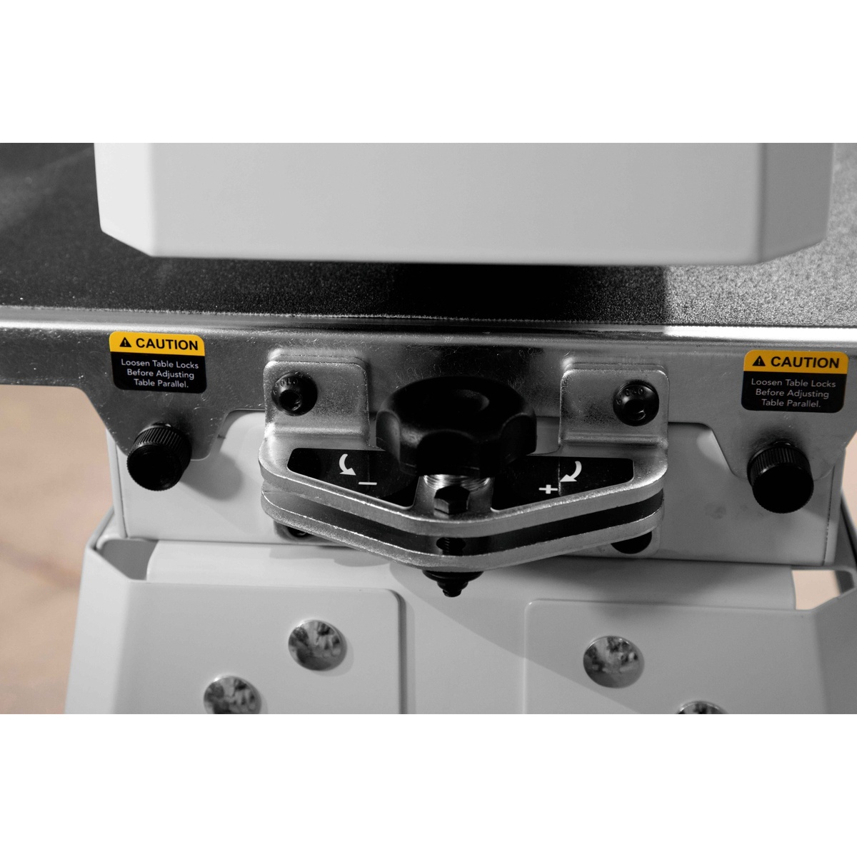 JET JWDS-1836 Drum Sander with Stand parallelism adjustment dial on the conveyor bed, shown in a workshop setup for accurate board sanding and thickness setup