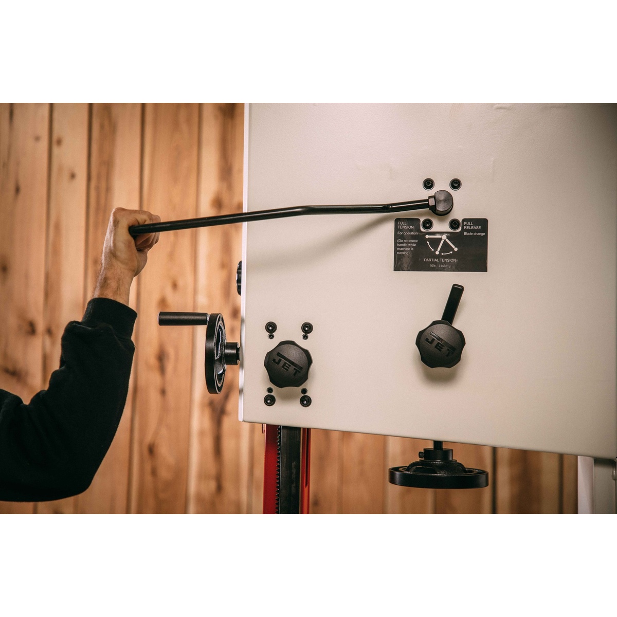 JET JWBS-15-3 15-Inch Woodworking Bandsaw quick-release blade tension control and adjustment knobs being used during setup in a wood shop