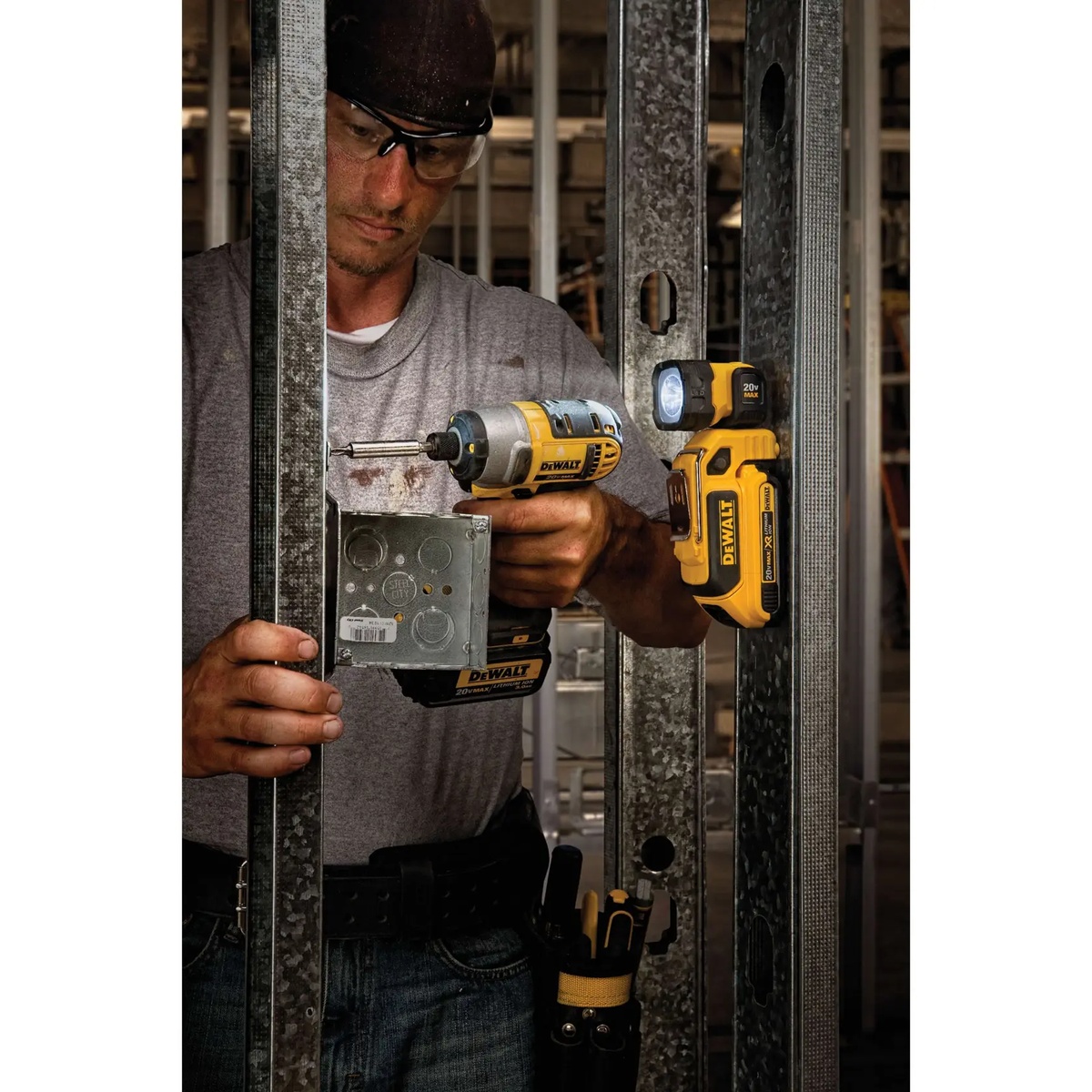 DEWALT DCL044 20V MAX Hand Held LED Work Light mounted to metal stud lighting an electrical box during framing and fastening work