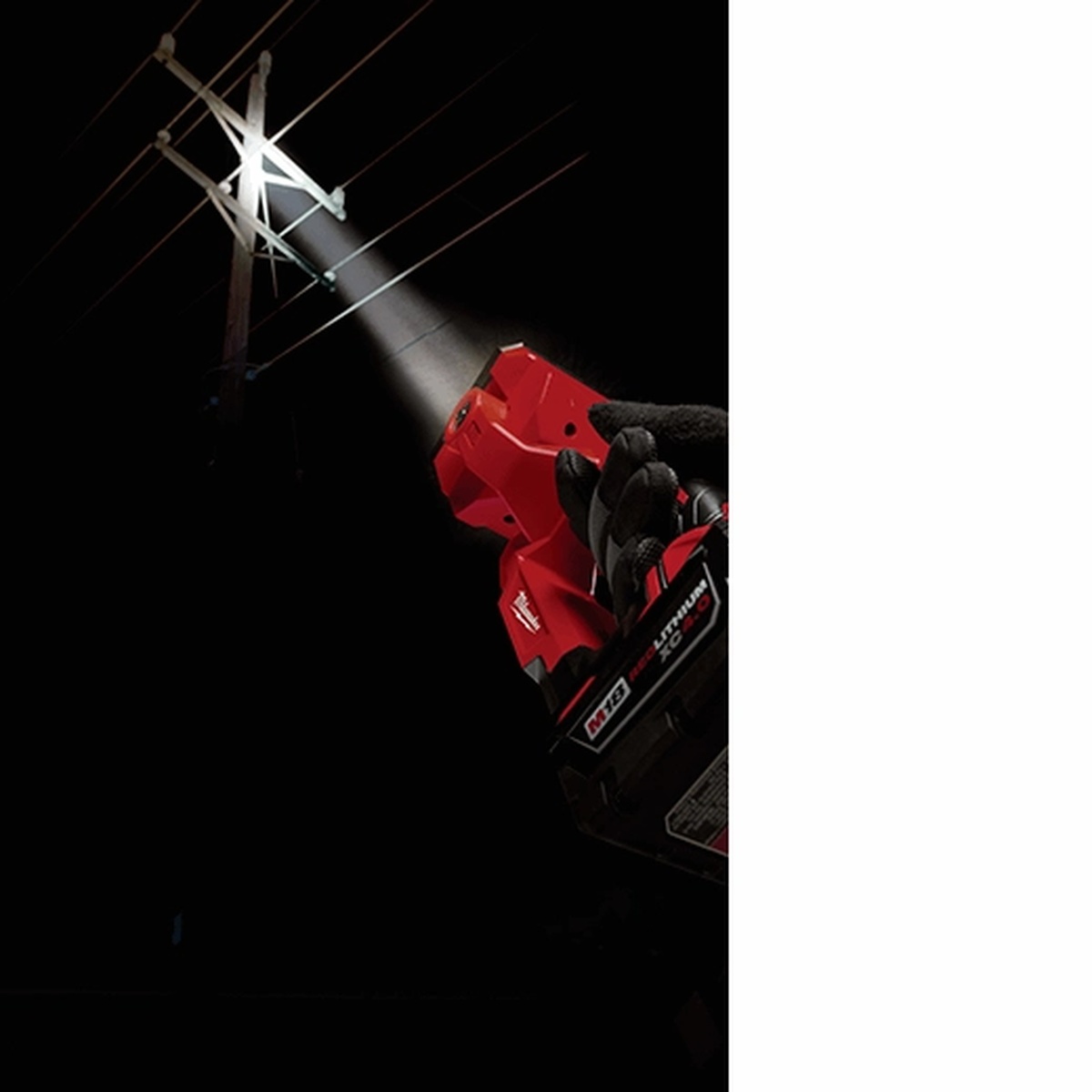 Milwaukee 2354-20 M18 Search Light illuminating a distant utility pole at night during field inspection work