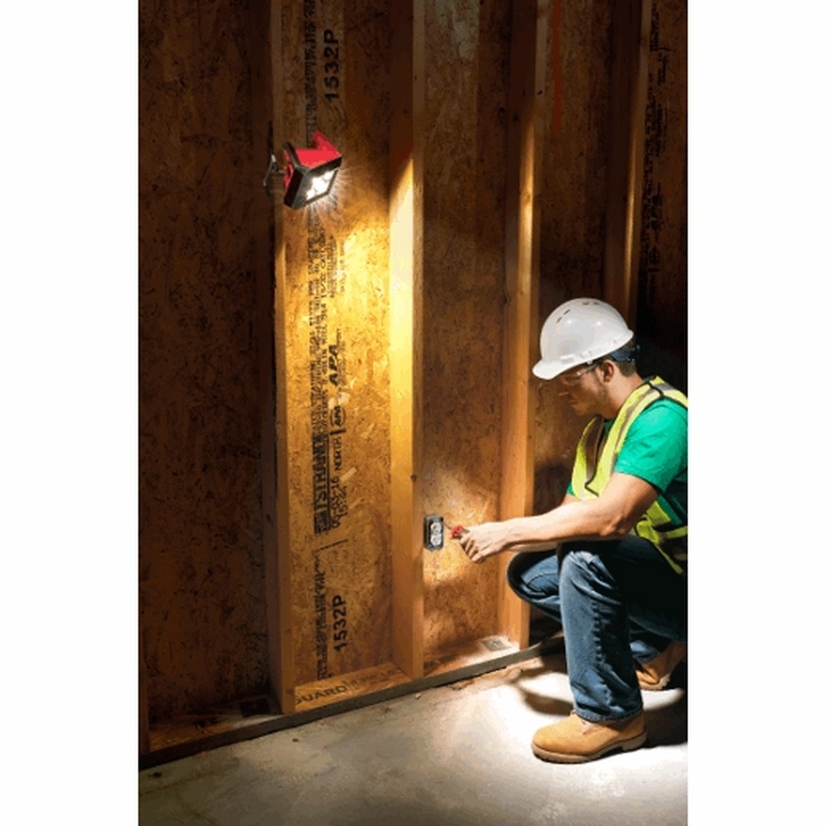 Milwaukee 2364-20 M12 ROVER Mounting Flood Light mounted on framing to illuminate electrical work inside a new construction wall