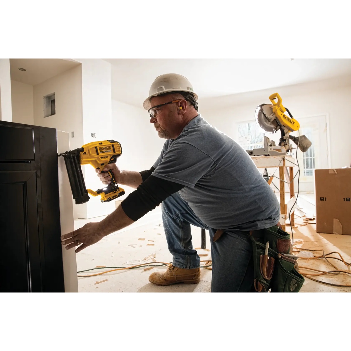 DEWALT DCN680B 20V MAX XR Cordless 18 Gauge Brad Nailer fastening trim on a cabinet side during interior finish work on a jobsite