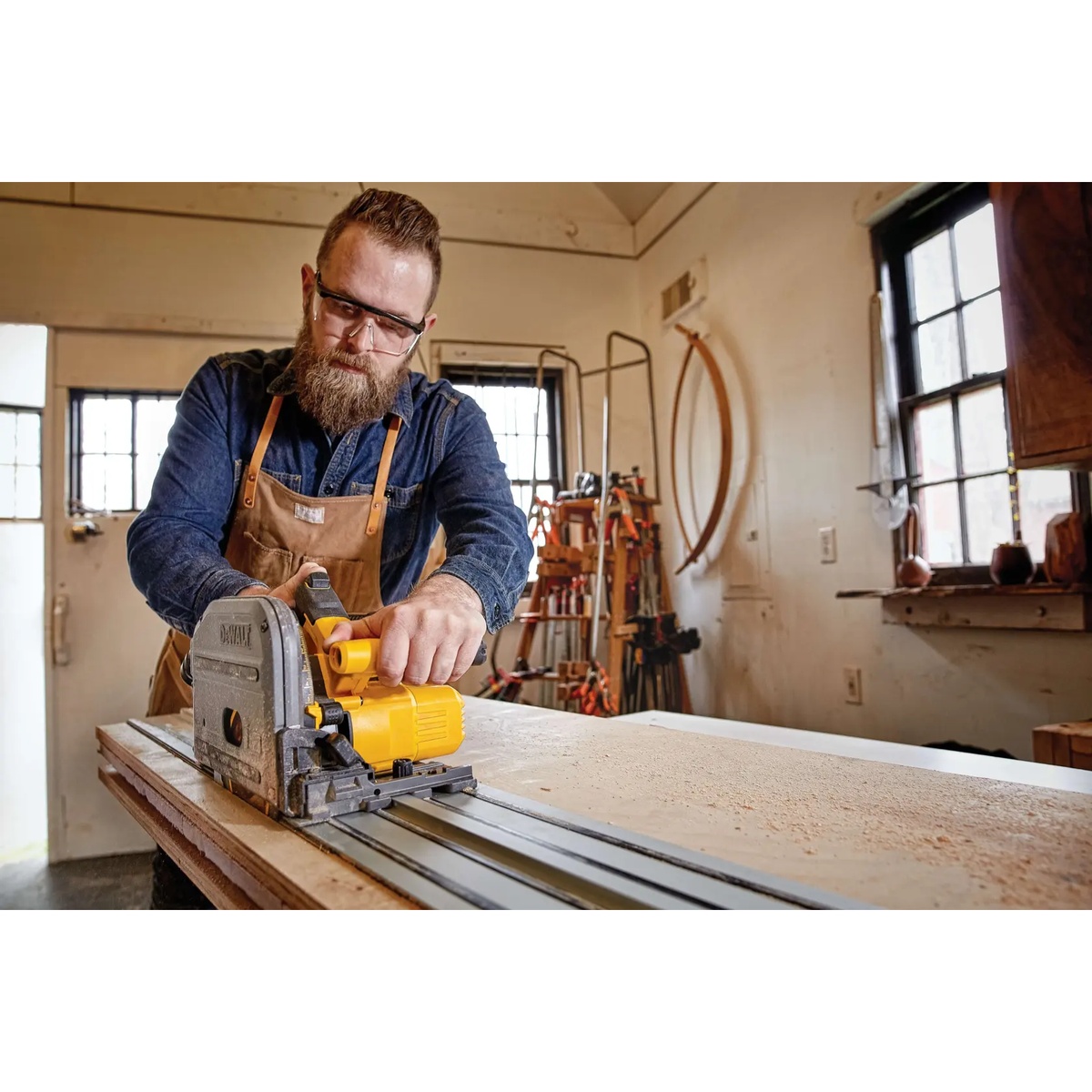 DeWALT DCS520T1 60V MAX Brushless Cordless 6-1/2-In. Track Saw Kit being used on a jobsite bench for precision woodworking cuts