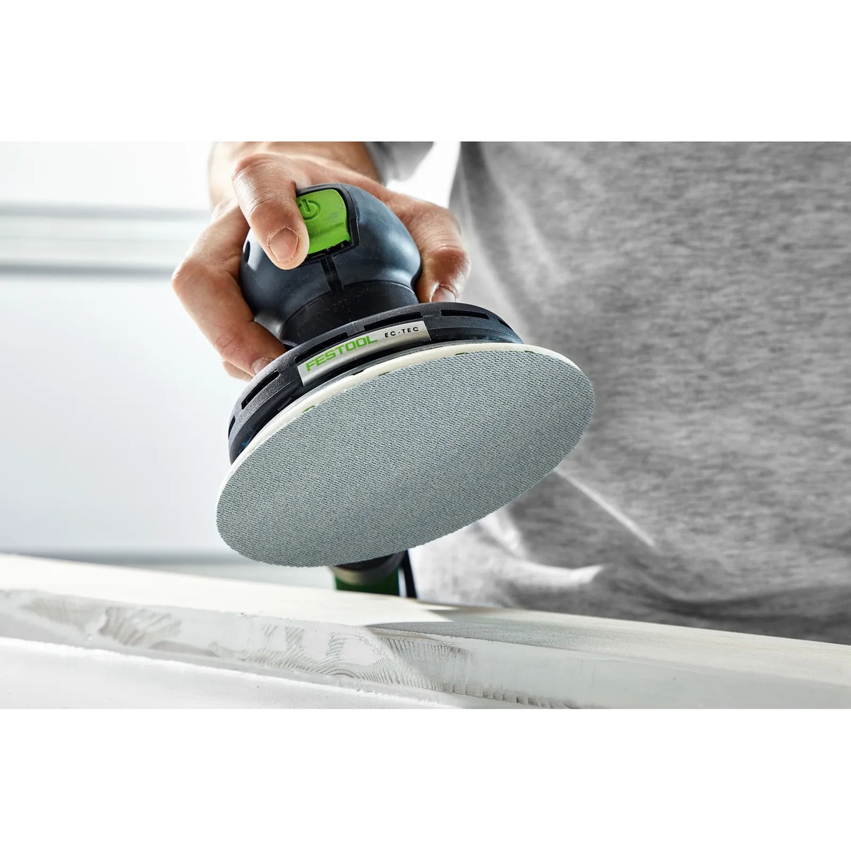 Festool PP D150/2 Protection Pad shown on a 6 inch Festool random orbit sander above a wood surface in a finish sanding setup