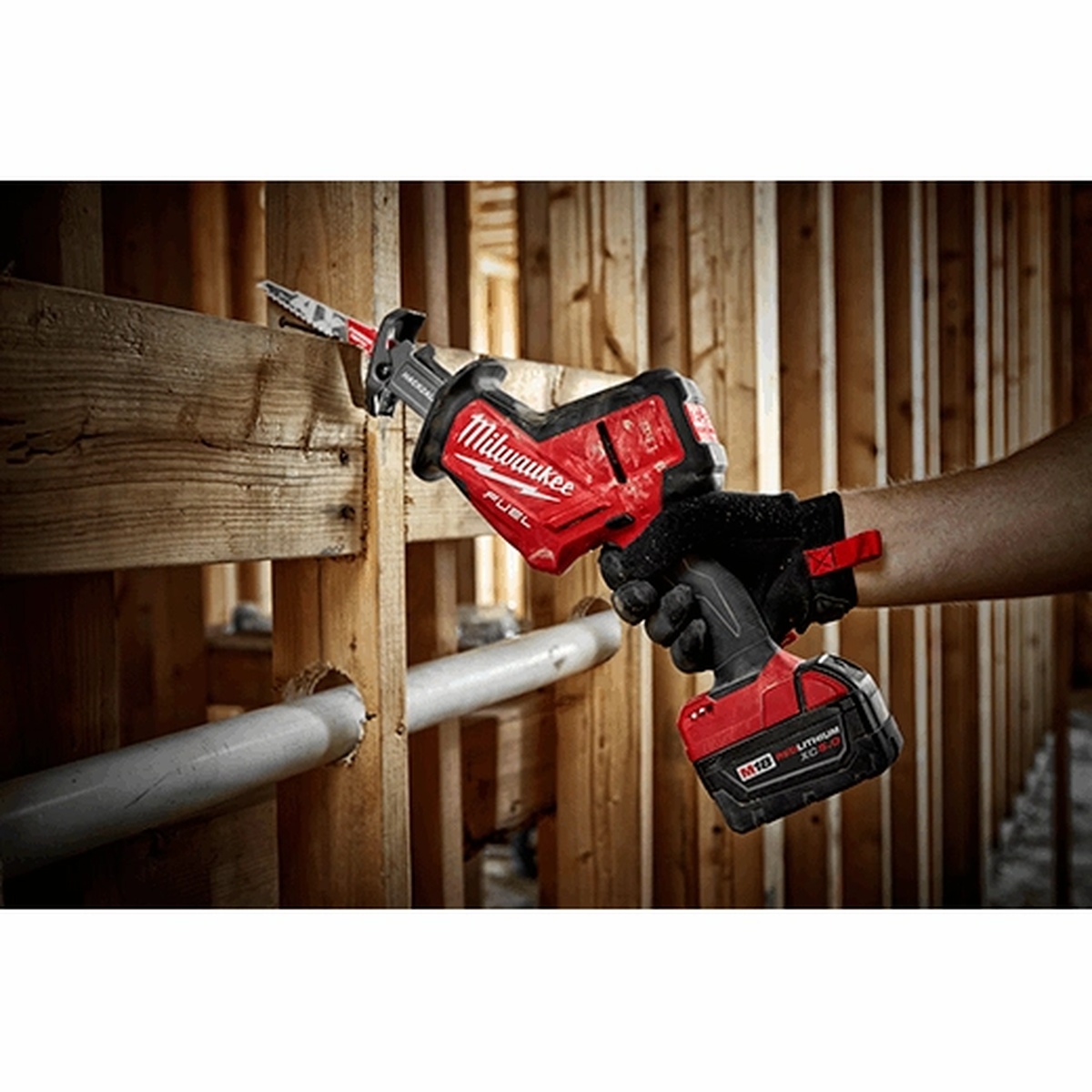 Milwaukee 2719-21 M18 FUEL HACKZALL Reciprocating Saw Kit cutting through wood framing inside a wall cavity during remodeling work