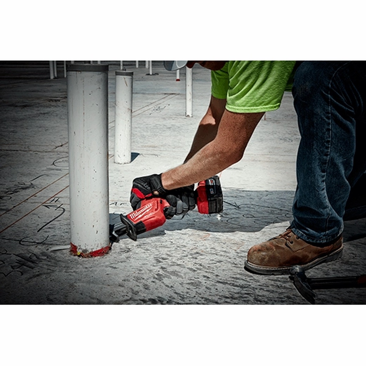 Milwaukee 2719-21 M18 FUEL HACKZALL Reciprocating Saw Kit cutting pipe at floor level on a construction site