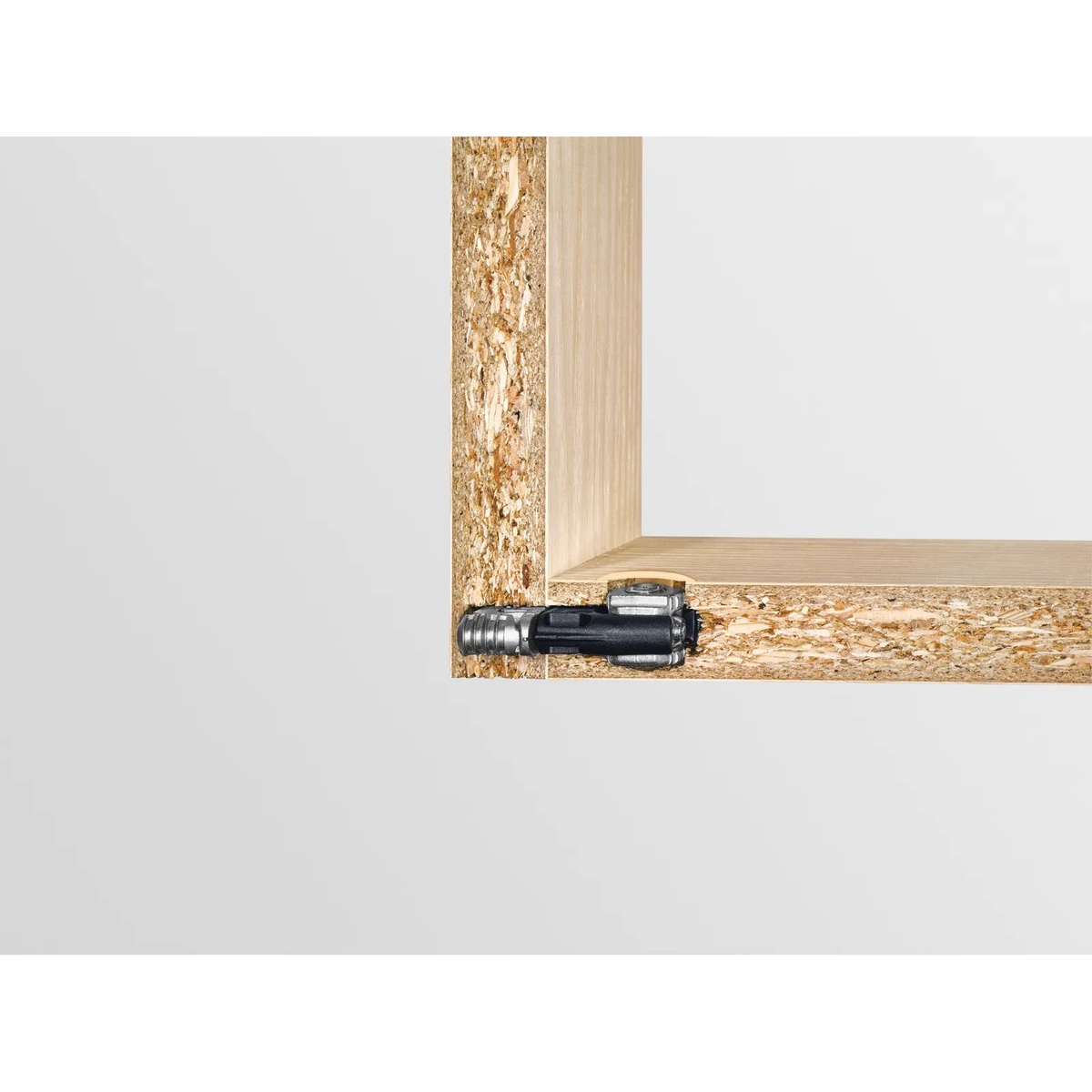 Festool panel connector installed in engineered wood corner joint showing concealed hardware in cabinet construction