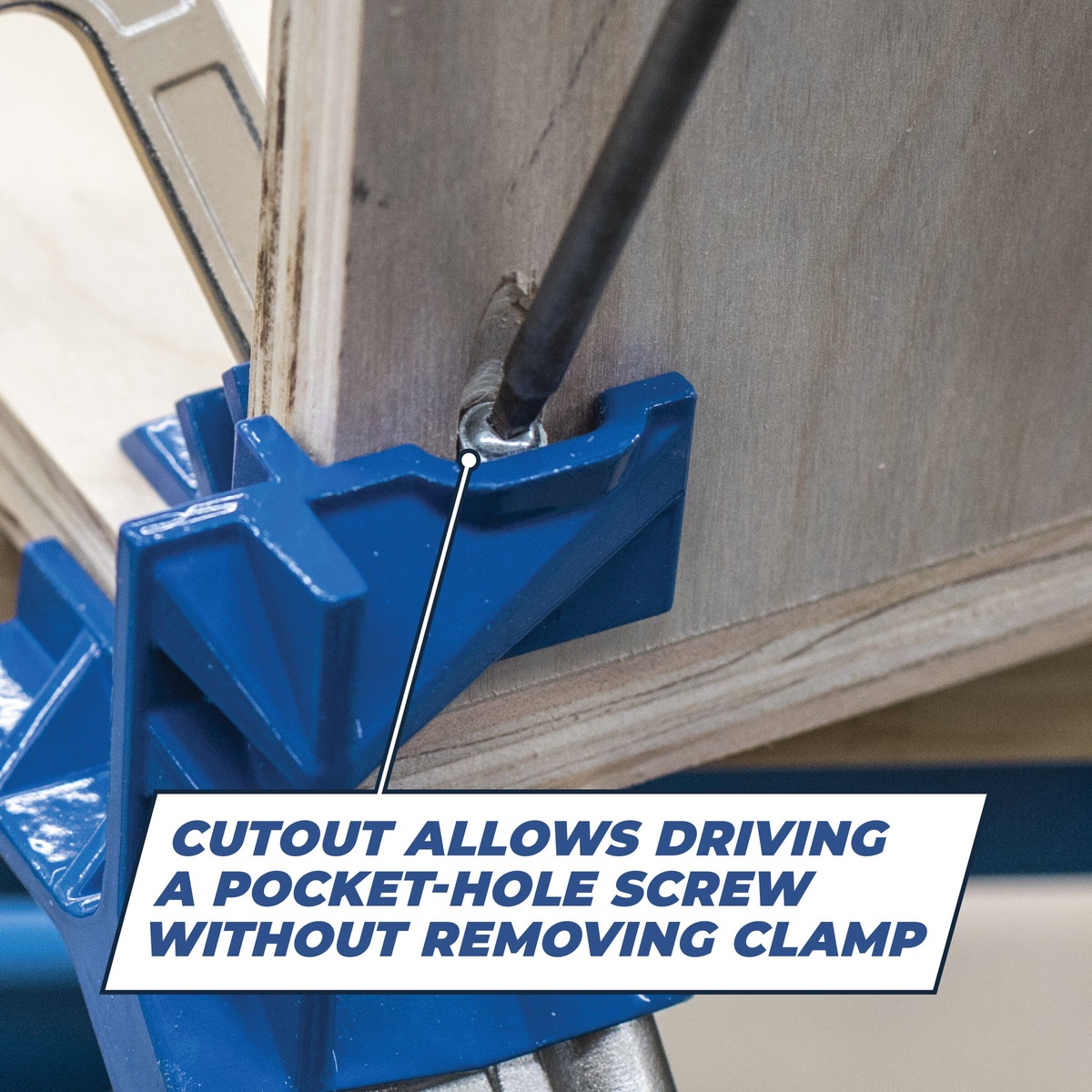 Kreg Automaxx 90° Corner Clamp close-up showing cutout access while driving a pocket-hole screw into a wood cabinet corner during assembly