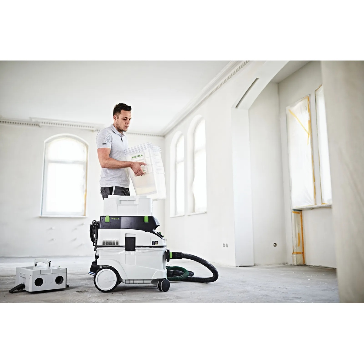 Festool 204083 CT Cyclone Dust Collection Pre-Separator CT-VA 20 used with a Festool CT dust extractor in a remodeling space to collect heavy dust during interior jobsite cleanup