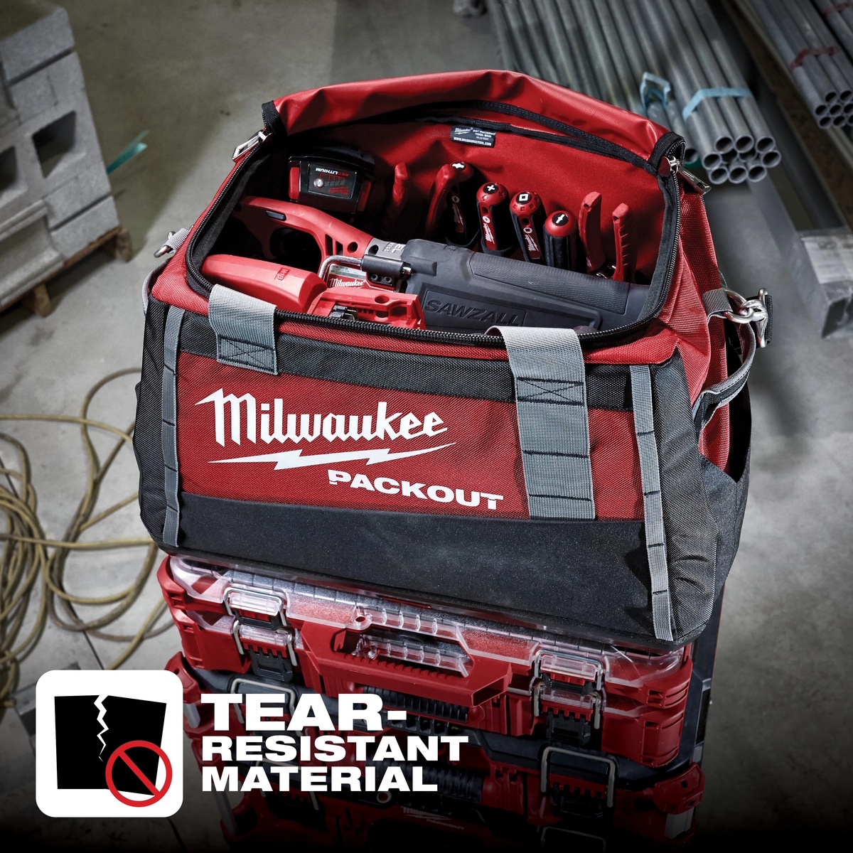 Milwaukee PACKOUT Tool Bag loaded with cordless tools and hand tools on a PACKOUT stack in a jobsite work area with insulated bottle nearby