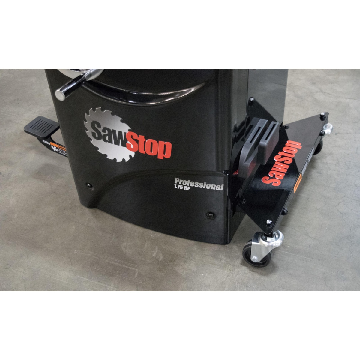 SawStop MB-PCS-000 Professional Integrated Mobile Base installed on a Professional Cabinet Saw on a concrete shop floor showing the caster and base in working position