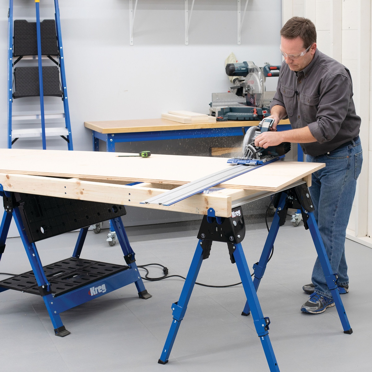 Kreg KWS500 Track Horse work support holding plywood steady while a track saw makes a cut on a workshop setup