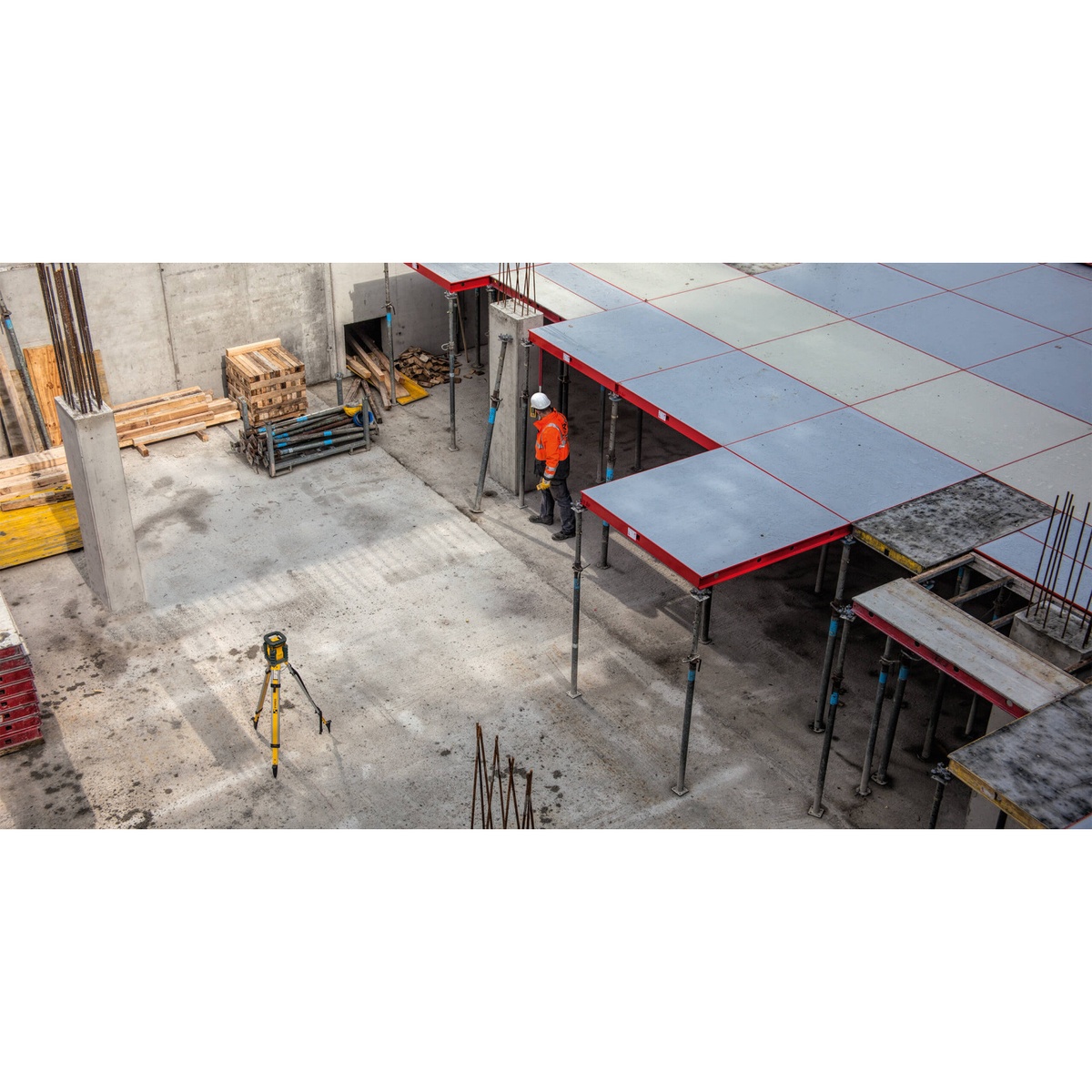 Stabila 05700TR LAR 350 Rotary Laser Kit set up on a tripod across a large concrete construction site for long-range layout and elevation work