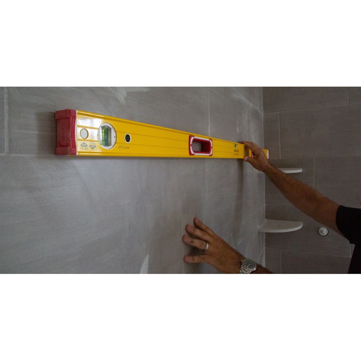 Stabila 37832 58-inch & 32-inch Type 196 2-Piece Spirit Level Set held against a tiled wall for layout and leveling during bathroom remodeling