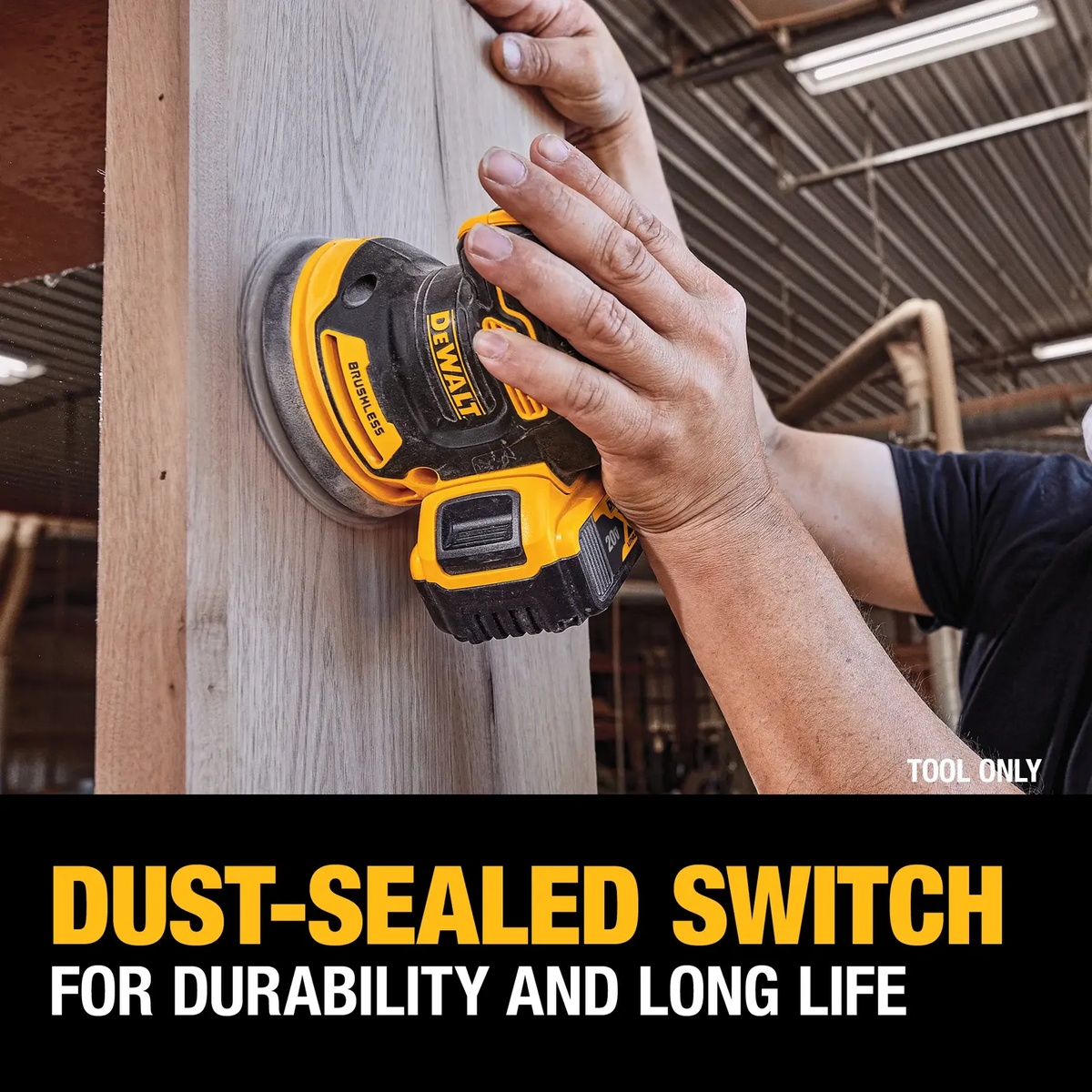 DEWALT DCW210B random orbital sander sanding a vertical wood panel in a workshop to show low-profile control and dust-sealed durability