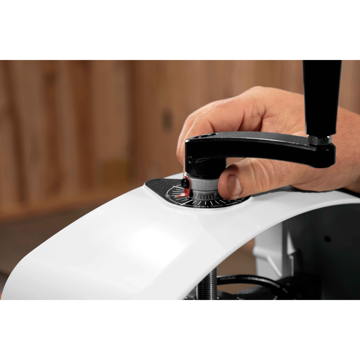 Jet 723540OSK JWDS-2244 Drum Sander With Stand handwheel and depth dial being adjusted in a woodworking shop for precise sanding setup