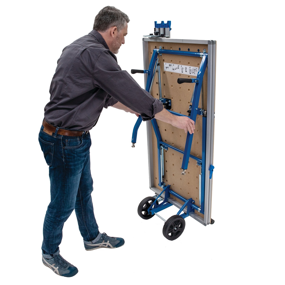 Kreg Adaptive Cutting System Project Table Base folding vertically on its wheels for compact upright storage behind the project table top