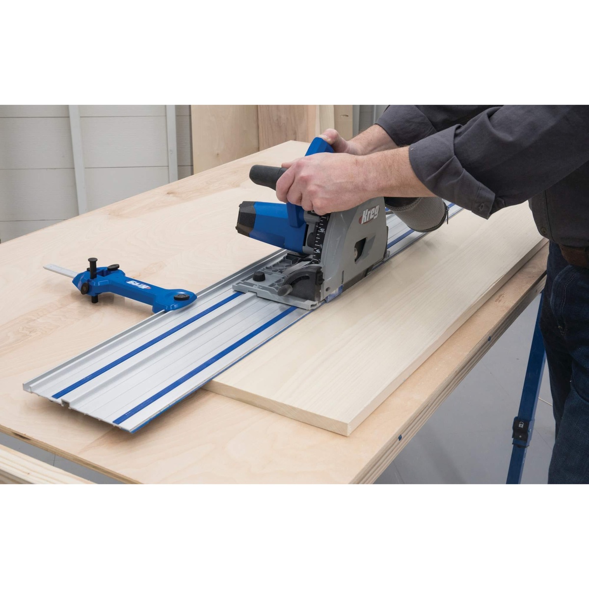 Kreg Tool ACS2000-KIT plunge saw cutting a wood panel on a guide rail during sheet goods breakdown on a workbench