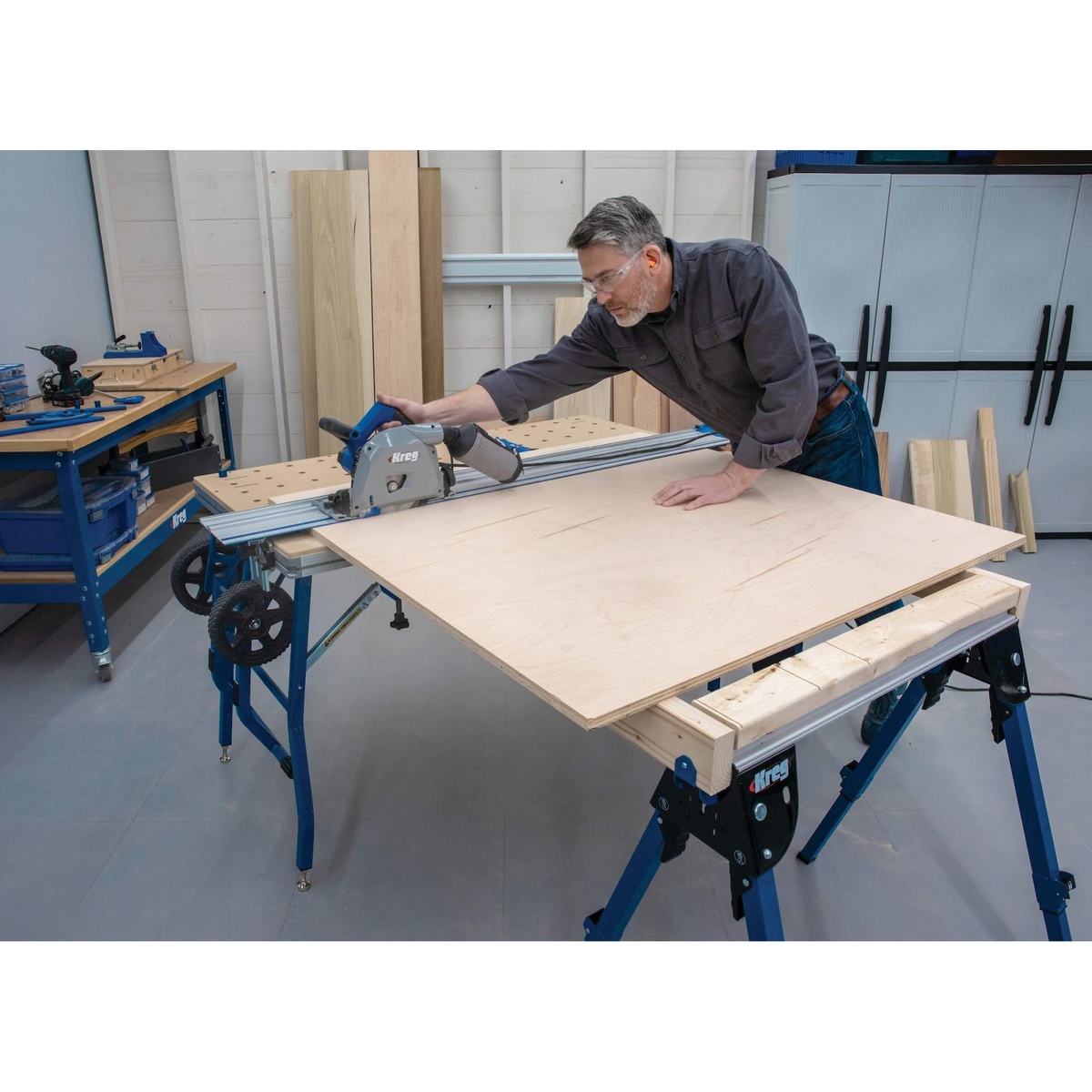 Kreg Tool ACS2000-KIT plunge saw system used on a large plywood panel in a workshop with portable support setup