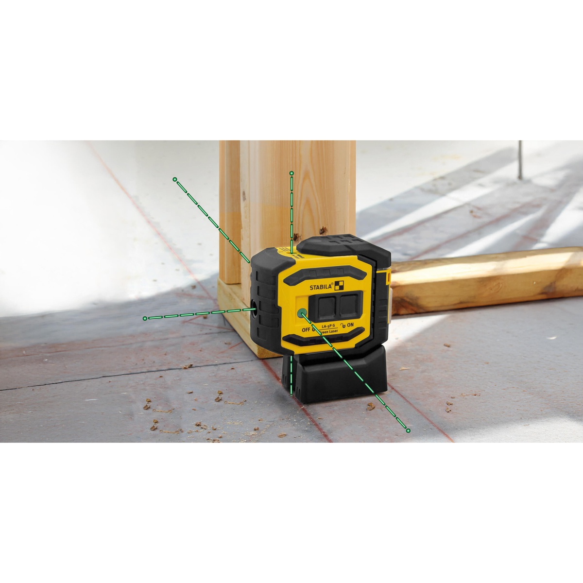 Stabila 03165 LA-5P Green 5 Point Laser Level Set positioning layout points at a wood framing corner for wall and partition alignment on a jobsite floor