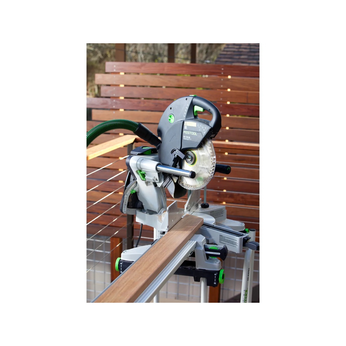 Festool Sliding Compound Miter Saw KAPEX KS 120 REB set up outdoors making a precise cut on finish trim stock