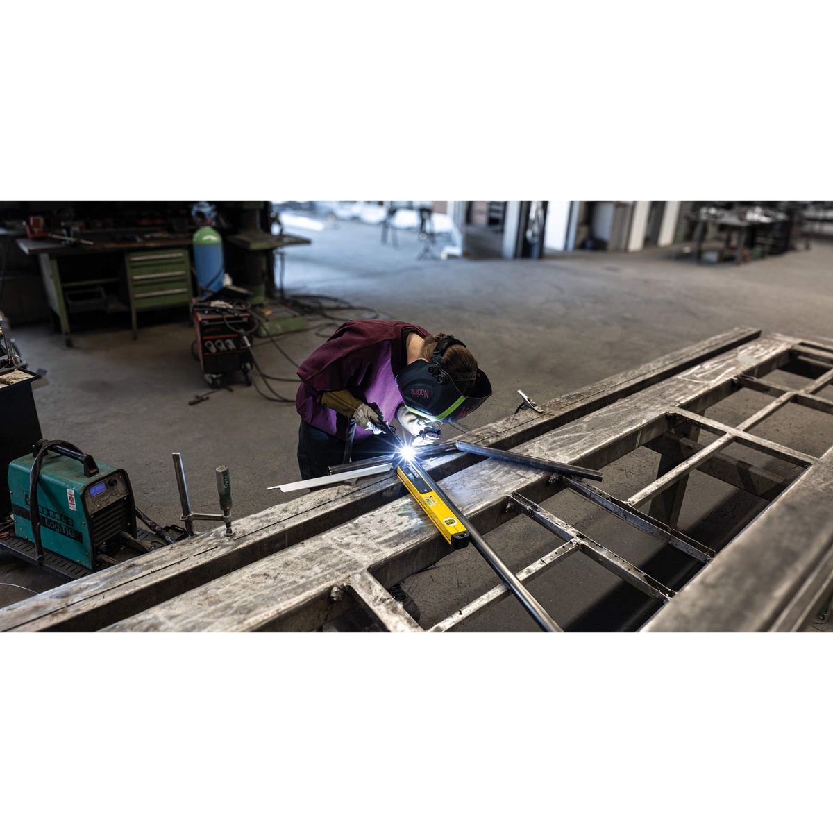 Stabila 39018 18-inch Digital Angle Finder TECH 700 DA in use on steel stock during fabrication work in a shop