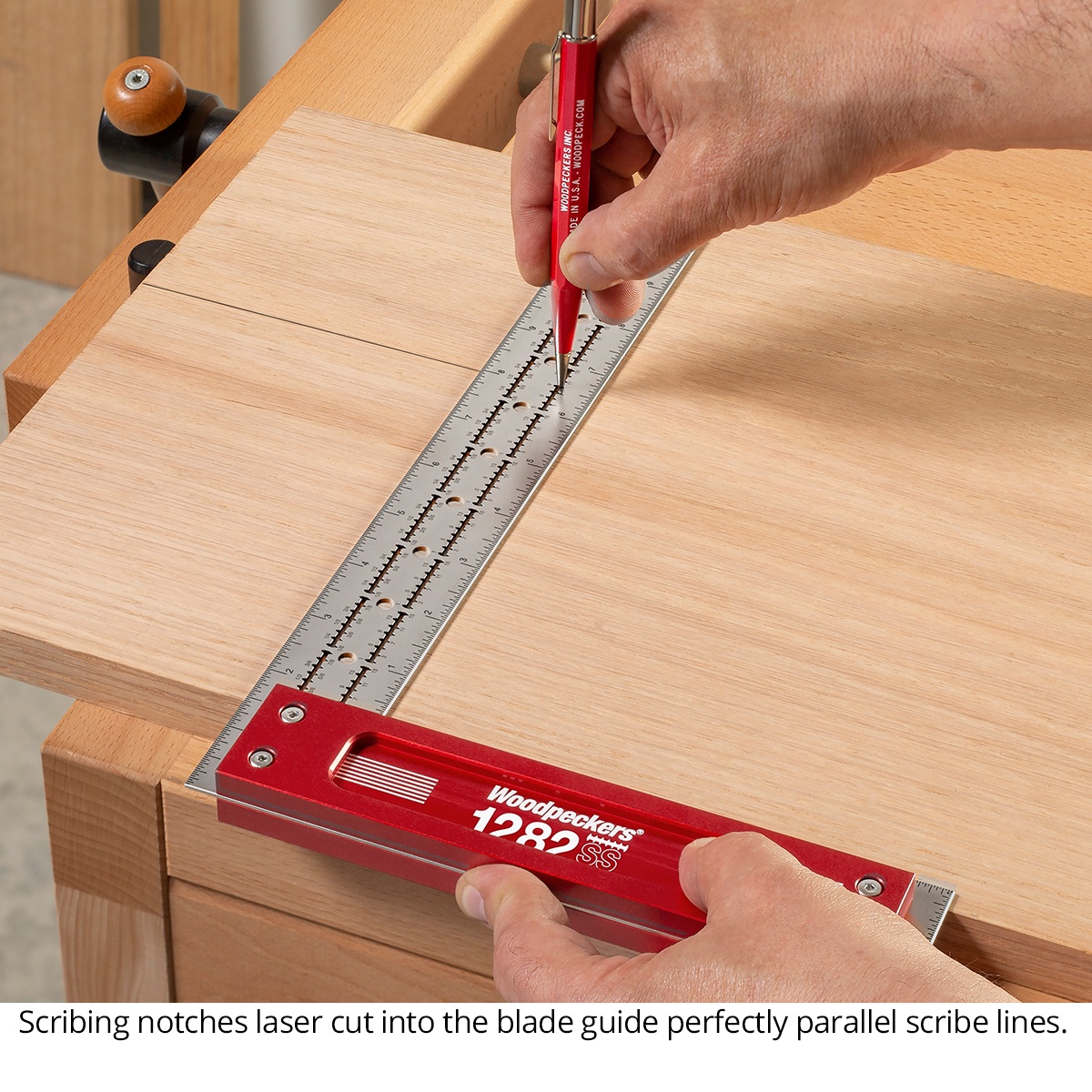 Woodpeckers SSSQ-12-24 Stainless Steel Square, 12 in. being used to scribe a parallel line on a wood panel with a pencil in a woodworking shop