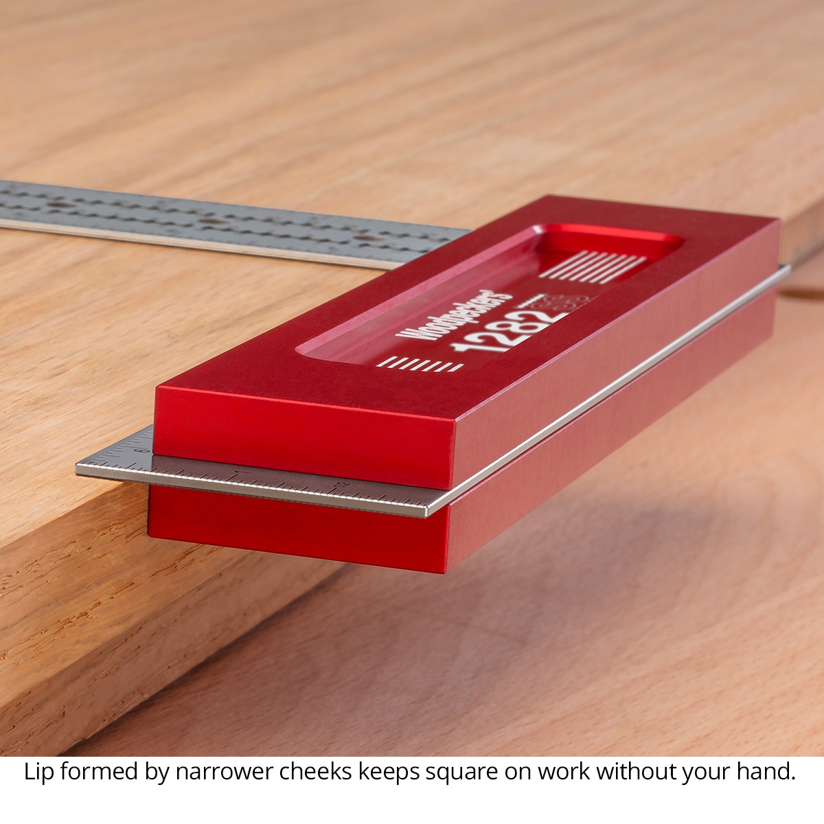 Woodpeckers SSSQ-12-24 Stainless Steel Square, 12 in. resting on the edge of a hardwood workpiece with the beam registered flat for stable woodworking layout