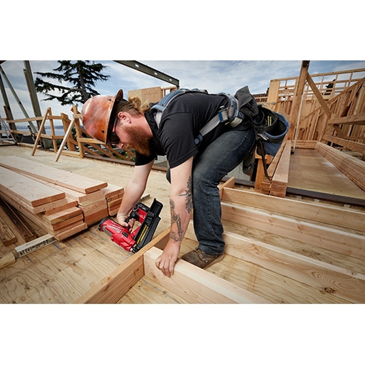 Milwaukee M18 FUEL 21 Degree Framing Nailer driving nails into wood framing on an active residential jobsite during structural fastening work