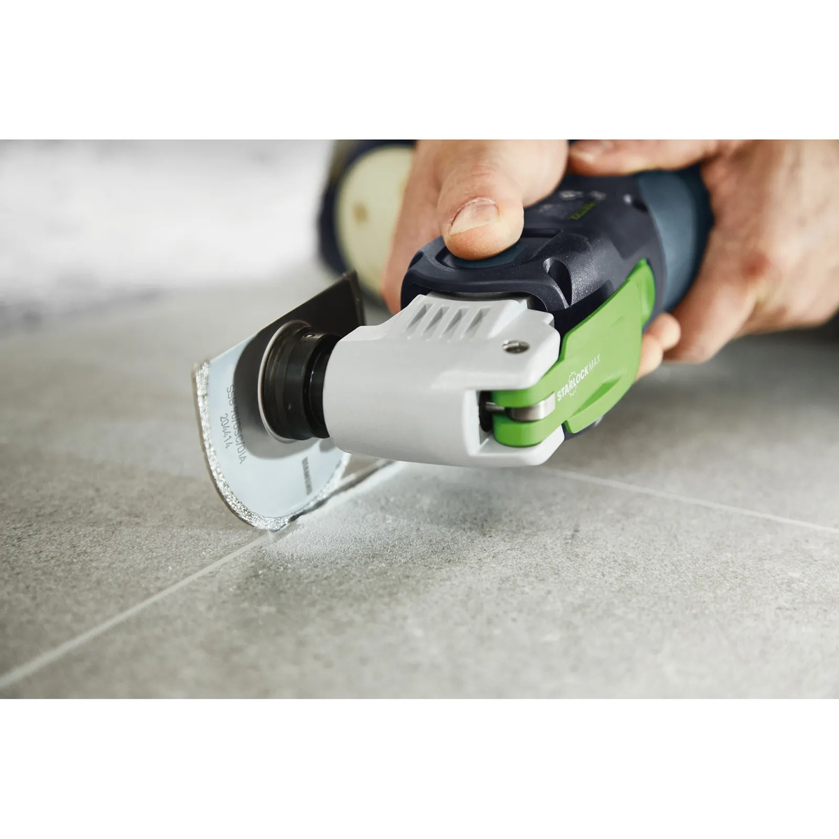 Festool 204414 Vecturo Starlock Diamond Saw Blade SSB 90, 1-Pack cutting a tile grout joint with an oscillating multi-tool during tile repair work