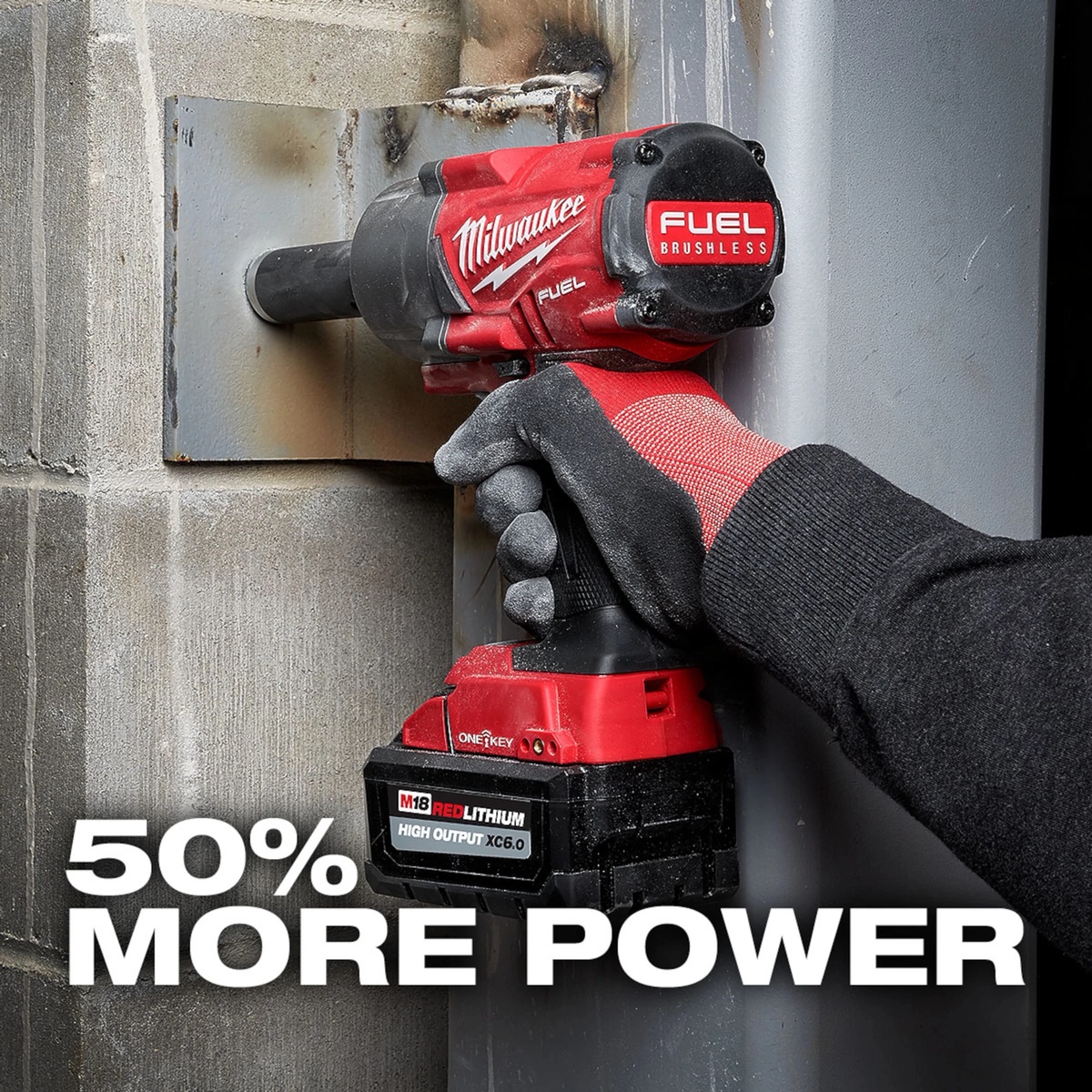 Milwaukee 48-11-1865 M18 REDLITHIUM HIGH OUTPUT XC6.0 Battery Pack installed on a cordless impact wrench during heavy steel fastening on a jobsite