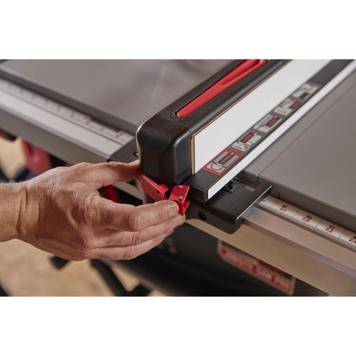SawStop Jobsite Saw Pro table saw fence locking close-up showing the Ergolock fence system on the aluminum table during setup