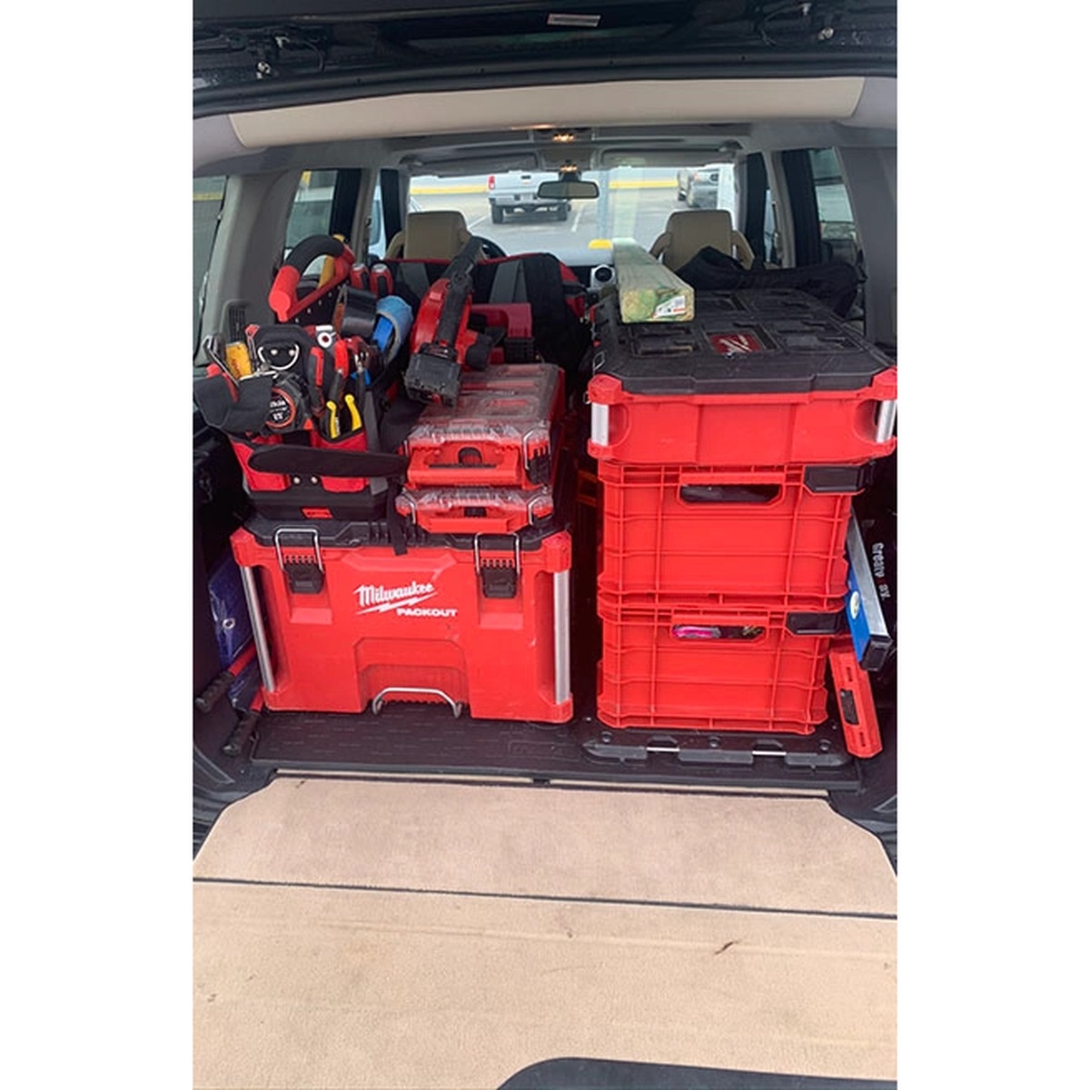 Milwaukee 48-22-8440 PACKOUT Crate loaded in the back of a vehicle with other PACKOUT storage for mobile jobsite transport and tool organization