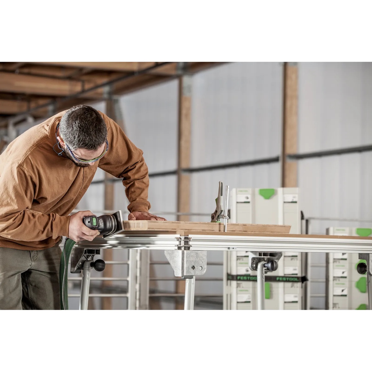 Festool 576054 RTS 400 REQ Orbital Sander smoothing a wood workpiece on a bench during finish sanding