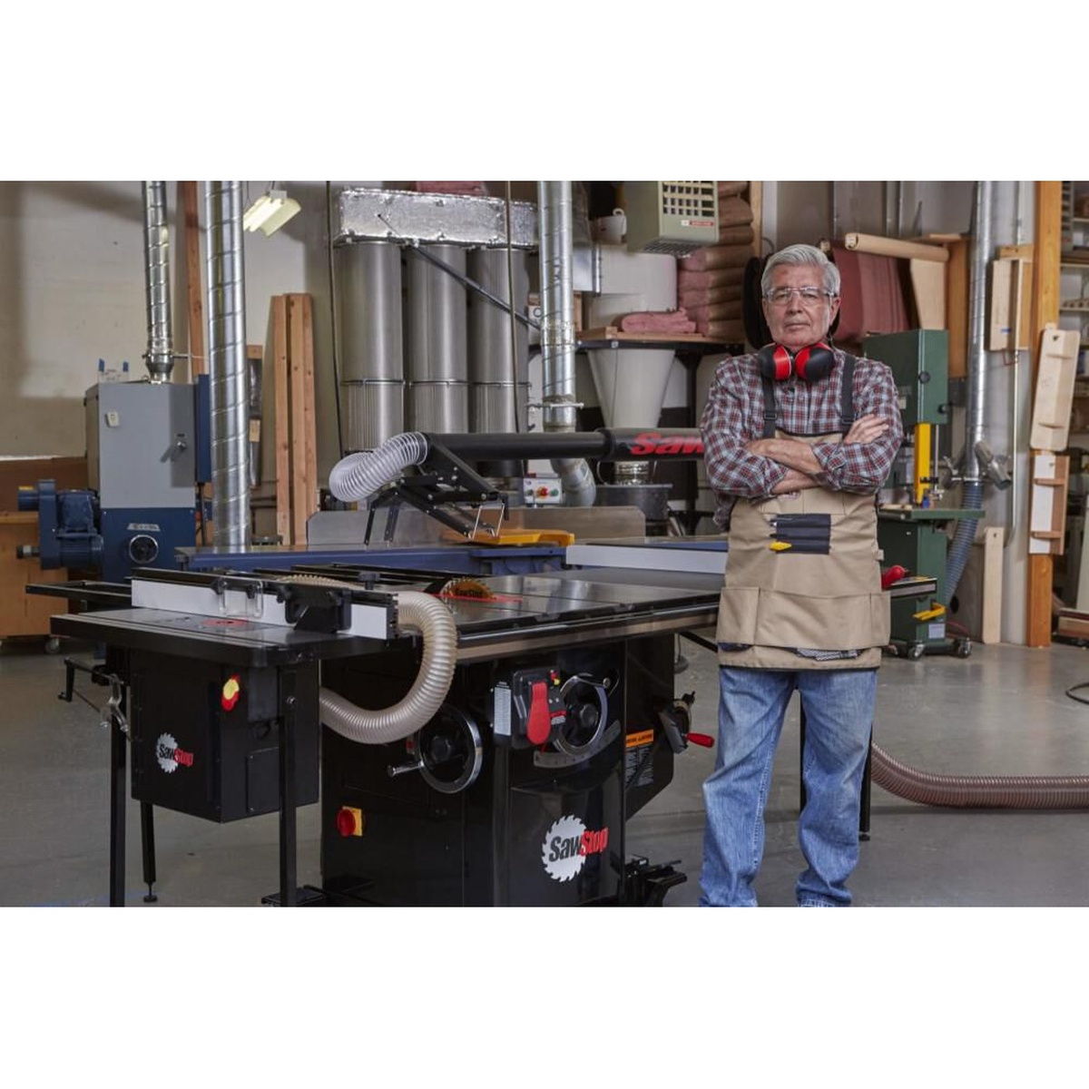 SawStop ICS51230-52 230V Single Phase 5-HP Industrial Cabinet Saw with 52 inch T-Glide Fence System set up in a professional woodworking shop with dust collection connected