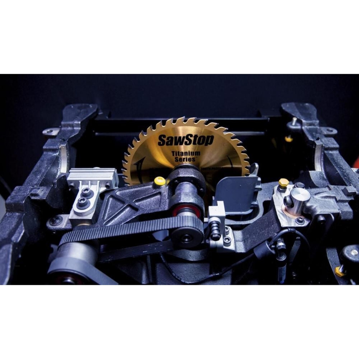 Close-up of SawStop industrial cabinet saw blade, drive system, and brake mechanism inside the cabinet saw assembly
