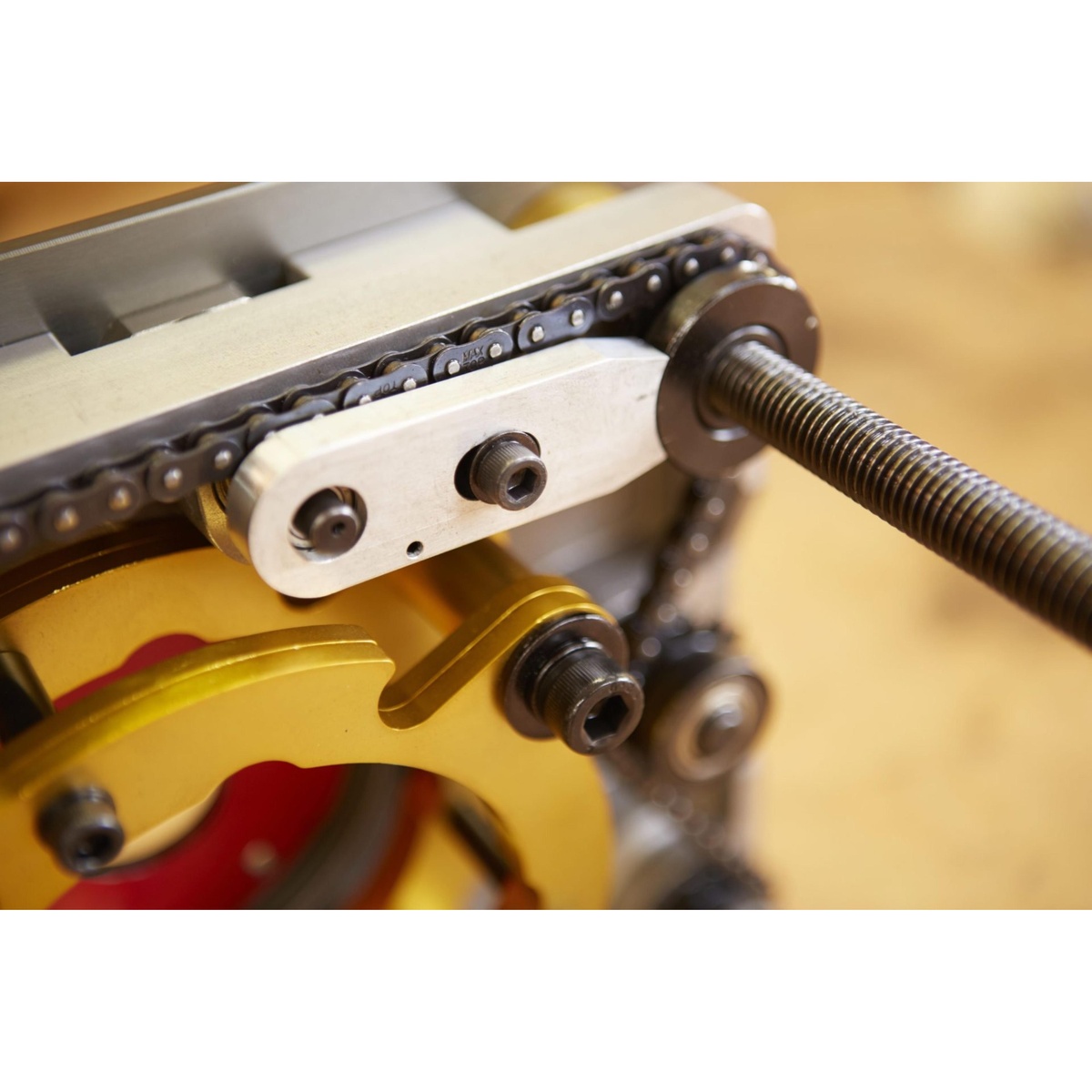 SawStop RT-LFT Four-Post Router Lift with Lock close-up showing chain-synchronized lift mechanism and threaded post on a woodworking bench