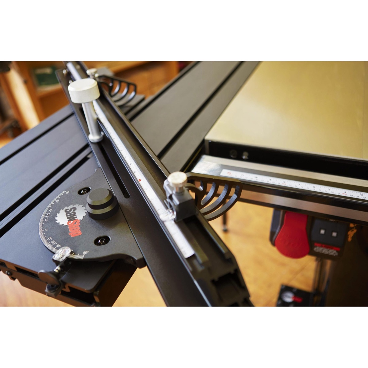 SawStop Sliding Crosscut Table fence, flip stop, and angle scale set up on a SawStop table saw for repeat crosscuts and miter cuts