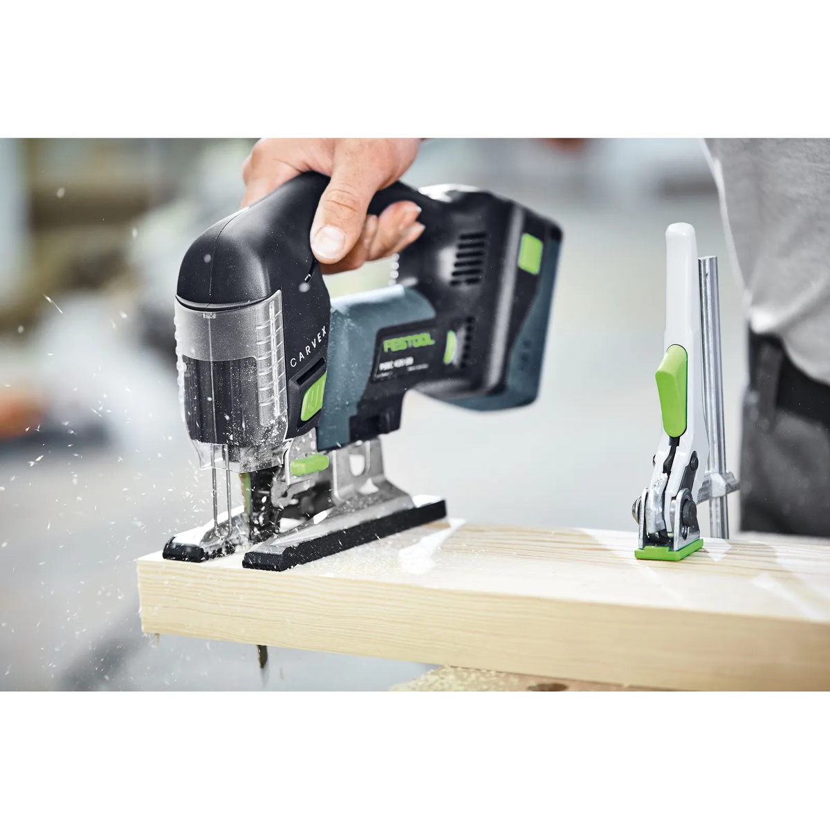 Festool Cordless Carvex Jigsaw PSBC 420 EB-Basic making a controlled cut in thick lumber on a jobsite bench