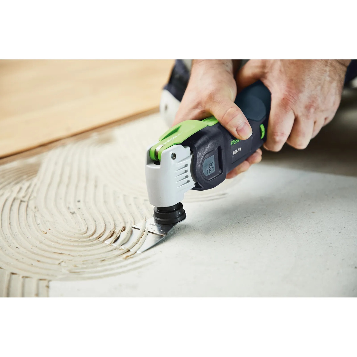 Festool 576589 Vecturo OSC 18 StarlockMax Cordless Multi-Tool BASIC cutting through flooring adhesive on a renovation jobsite floor