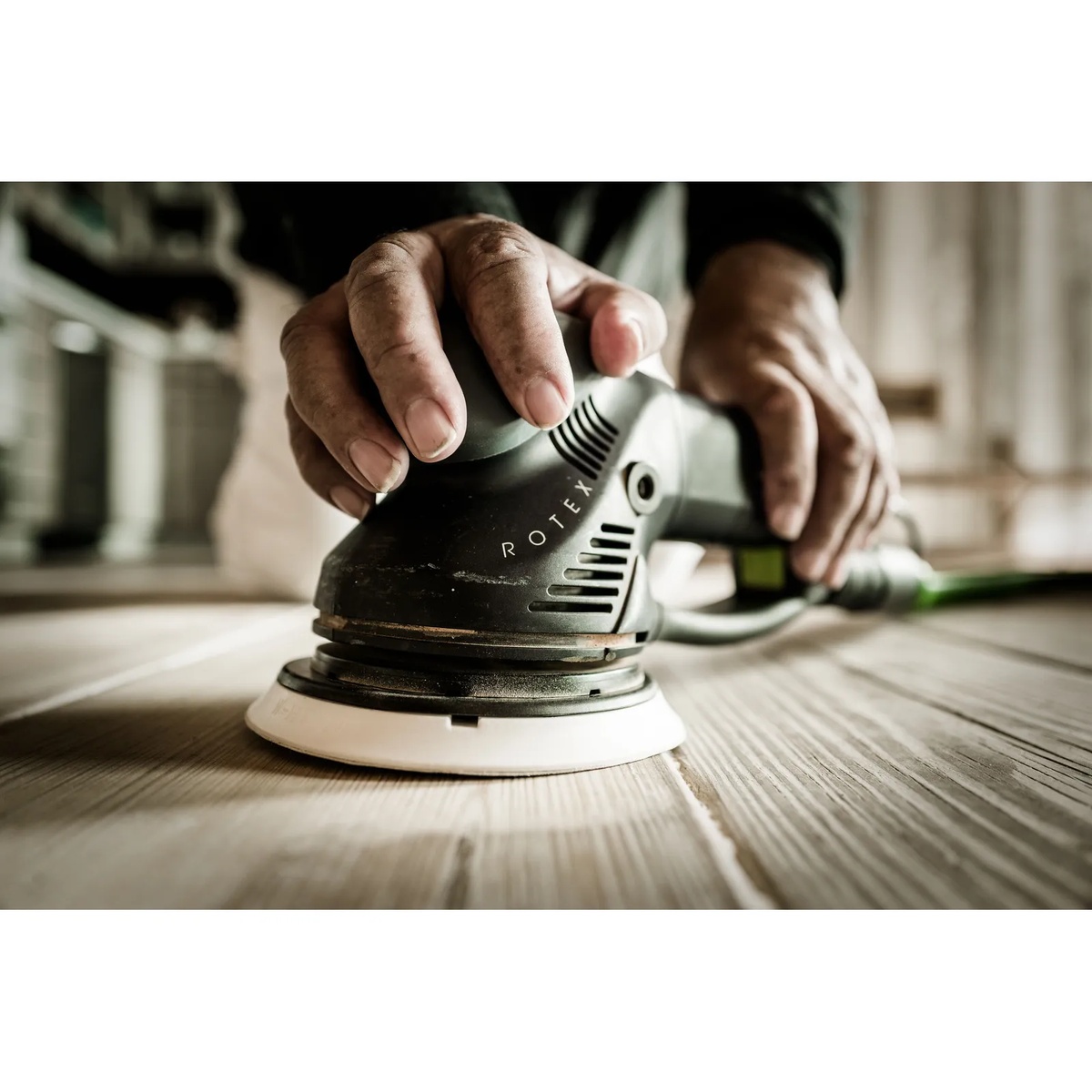 Festool 576028 RO 150 150mm (6 inch) FEQ Rotex Sander sanding a wood plank in a workshop during surface prep