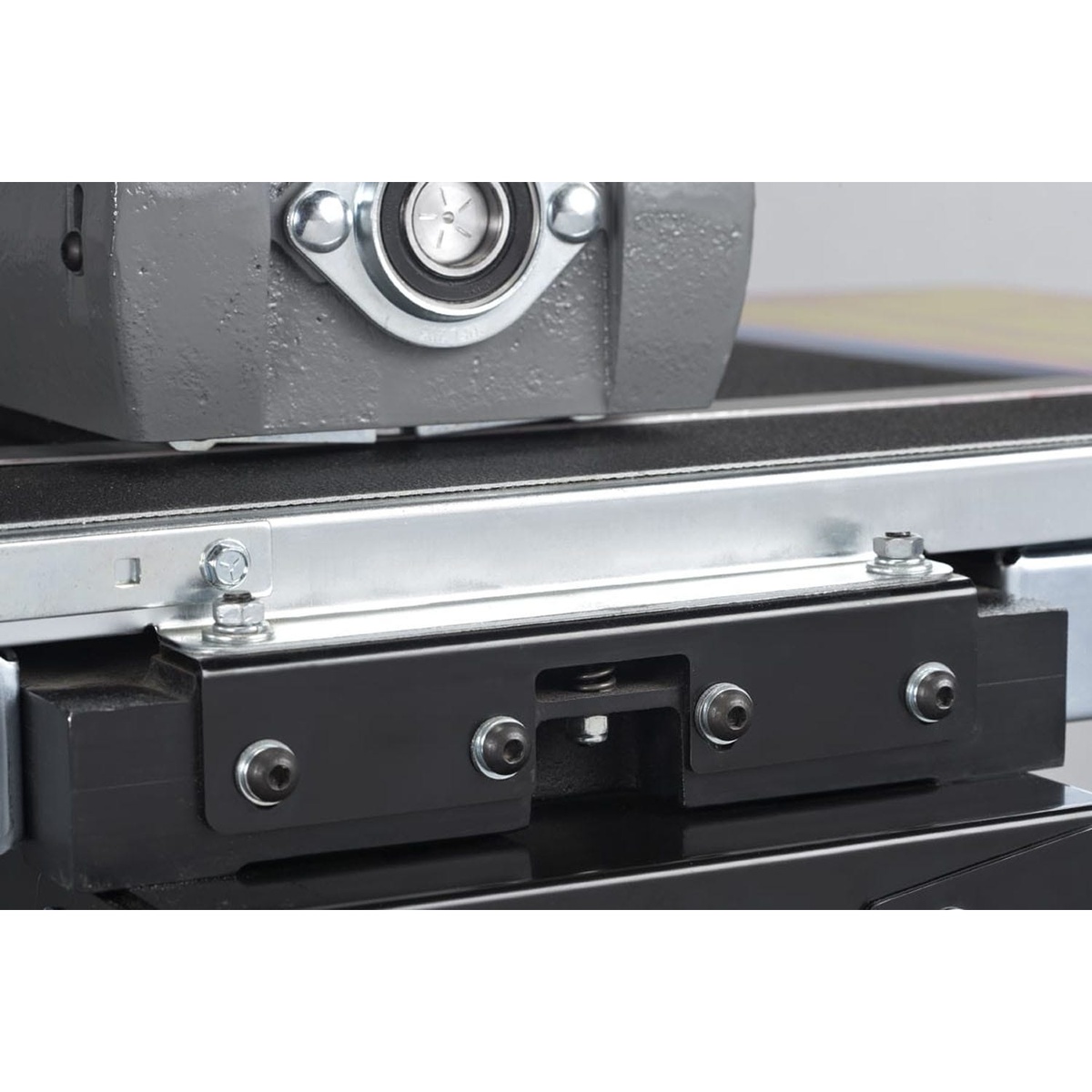 Close-up of the Supermax SUPMX-71938-D 19-38 drum sander conveyor and alignment hardware, highlighting precision feed control for consistent sanding on wood stock