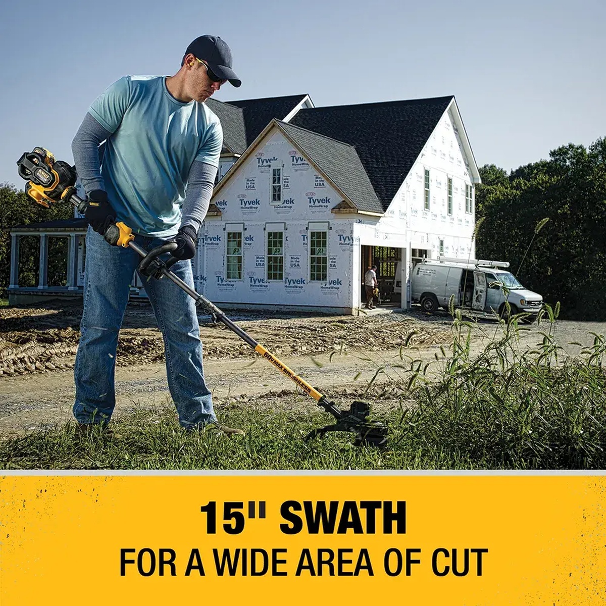 DEWALT DCST970X1S FLEXVOLT 60V MAX 15-In. Brushless Cordless String Trimmer Kit trimming tall grass beside a house under construction on a residential jobsite