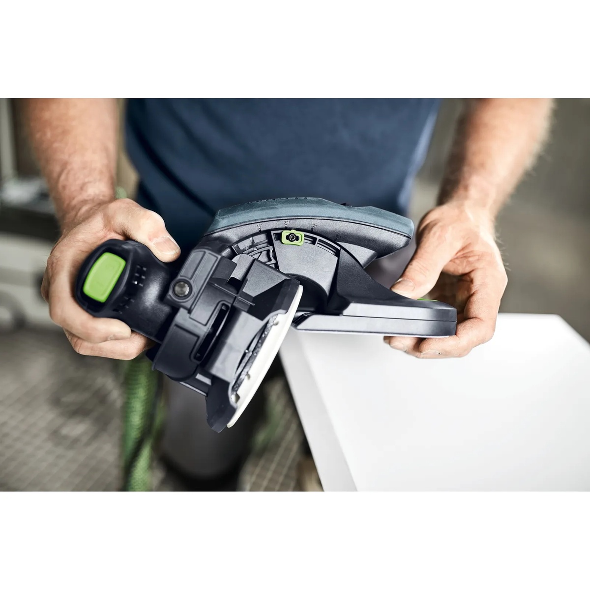 Festool 205316 Edge Sanding Guide for ETS/ETSC 125 Sanders attached to a sander and positioned on the edge of a white panel during finish sanding work