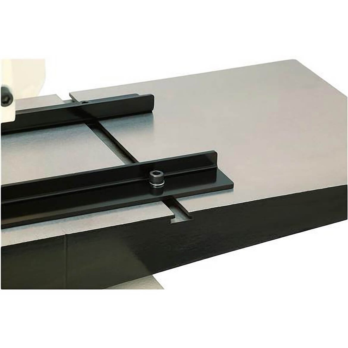 Cast iron extension wing and guide slot detail on the Shop Fox W1812 7-Inch Planer / Moulder with Stand for supporting wood stock during planing and moulding